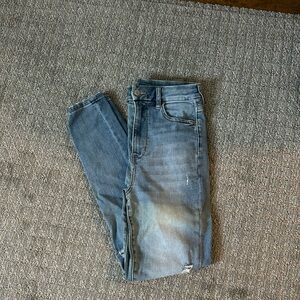 American Eagle light blue skinny jeans with rips at the knee